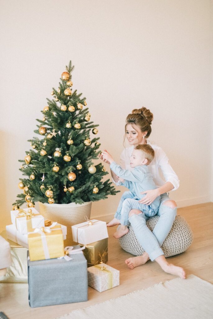 Mother And Child Decorating The Tree